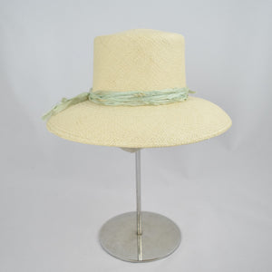 Panama straw with pale green distressed silk ribbon. Side view.