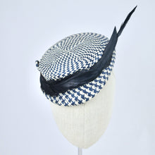 Load image into Gallery viewer, Short brimmed perching cap made in navy and white buntal straw with feathers.  Front view.