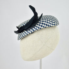 Load image into Gallery viewer, Short brimmed perching cap made in navy and white buntal straw with feathers. Side view.