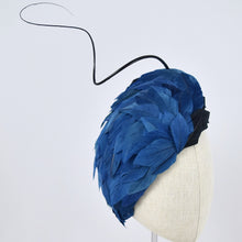 Load image into Gallery viewer, Tear dropped shape percher with peacock blue and black feathers with a dramatic curled quill.  3/4 front view.