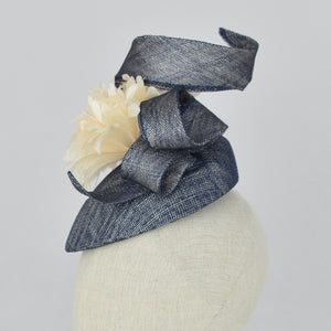 Navy blue sinamay tear drop percher with handmade flower and sinamay trim. Side view.