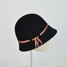 Load image into Gallery viewer, Black fur felt with narrow coral colored ribbon in a classic cloche style. Side view.