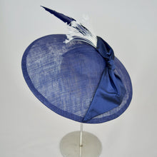 Load image into Gallery viewer, Royal blue sinamay saucer with silk bow and hand dyed feathers on a bandeau base. Rear view.
