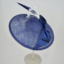 Load image into Gallery viewer, Royal blue sinamay saucer with silk bow and hand dyed feathers on a bandeau base. Rear view.
