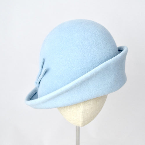 Baby blue velour fur felt with an asymmetrical flip. Front view.