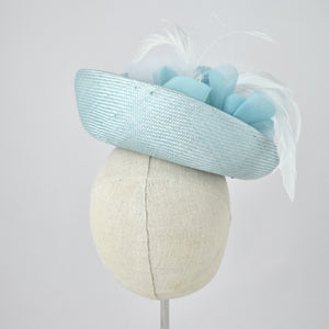 Saucer hat in ice blue parisisal with silk and feather trim.  Back view.
