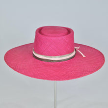 Load image into Gallery viewer, Shocking pink panama straw with a telescope crown and wide, flat brim. Back view.
