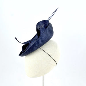 Navy blue parisisal saucer with burnt pheasant feather and parisisal trim.  Side view.