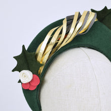 Load image into Gallery viewer, Forest green headband with felt trim and metal leaf, detail showing holly felt trim and metal leaf twirl
