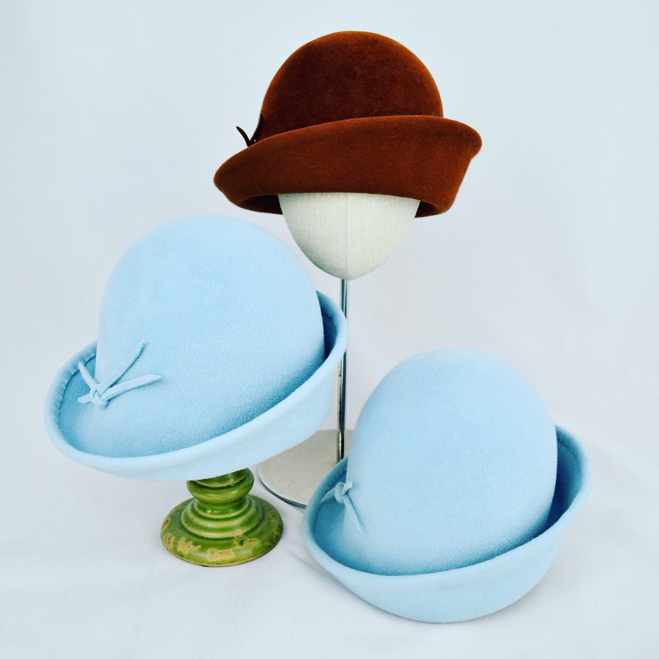 Velour fur felt with an asymmetrical flip. Different sizes in chocolate brown and baby blue.