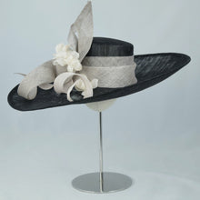 Load image into Gallery viewer, Beautiful wide sweeping brim in black and white sinamay, with sinamay swirls and hand made flowers. 
