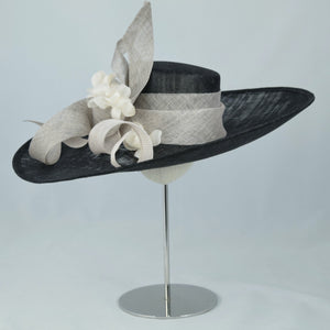Beautiful wide sweeping brim in black and white sinamay, with sinamay swirls and hand made flowers. 