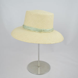 Panama straw with pale green distressed silk ribbon. Side view.