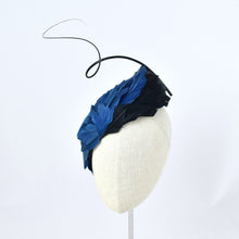 Load image into Gallery viewer, Tear dropped shape percher with peacock blue and black feathers with a dramatic curled quill.  Front view.

