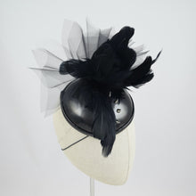 Load image into Gallery viewer, Cocktail hat in wet look vinyl with feathers, tulle, and studs. 3/4 front view.
