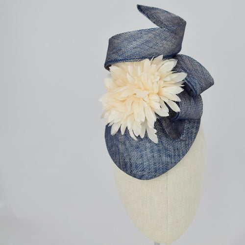 Navy blue sinamay tear drop percher with handmade flower and sinamay trim. Front view.