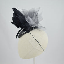 Load image into Gallery viewer, Cocktail hat in wet look vinyl with feathers, tulle, and studs. Side view.
