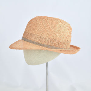 Fedora in peach colored knotted sisal.  Side view.