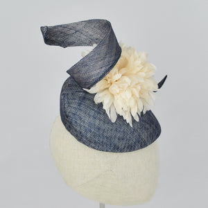 Navy blue sinamay tear drop percher with handmade flower and sinamay trim. Side view.