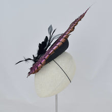 Load image into Gallery viewer, Black parisisal saucer with pink lady amherst feather, black and grey feathers, studs, and a vintage leather buckle. Side view.
