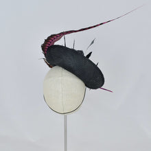 Load image into Gallery viewer, Black parisisal saucer with pink lady amherst feather, black and grey feathers, studs, and a vintage leather buckle. Back view.
