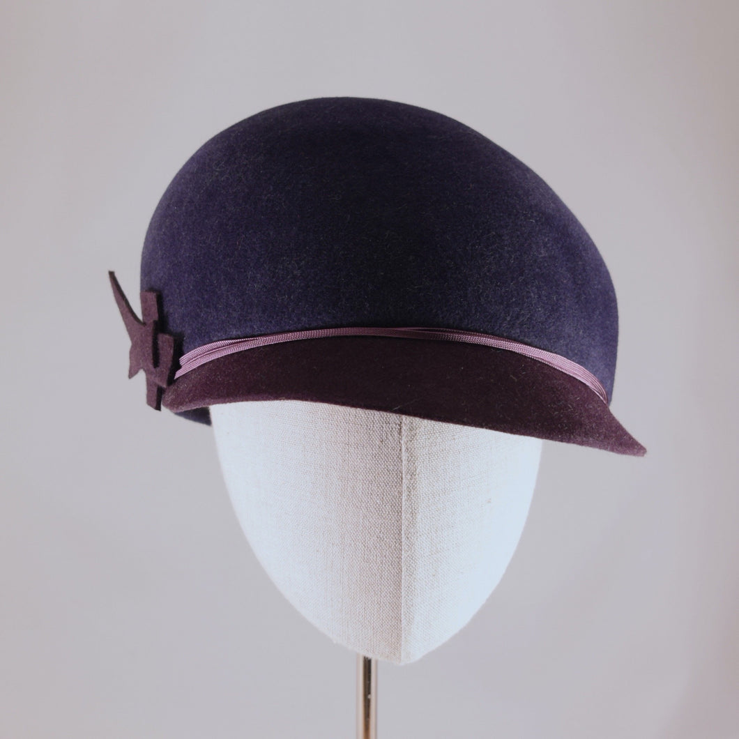 Indigo velour felt cap with violet visor.  Front view.