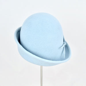 Baby blue velour fur felt with an asymmetrical flip. Back view.