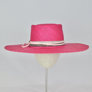 Shocking pink panama straw with a telescope crown and wide, flat brim. Front view.