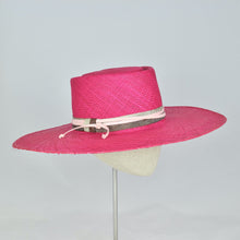 Load image into Gallery viewer, Shocking pink panama straw with a telescope crown and wide, flat brim. Side view.
