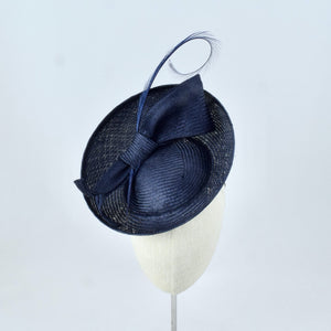Navy blue parisisal saucer with burnt pheasant feather and parisisal trim.  Front view.