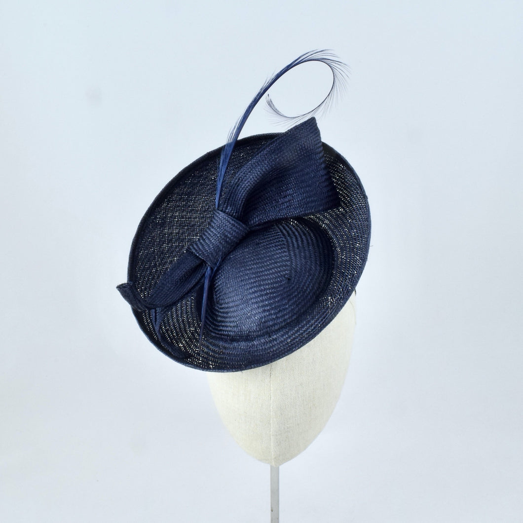 Navy blue parisisal saucer with burnt pheasant feather and parisisal trim.  Front view.