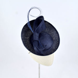 Navy blue parisisal saucer with burnt pheasant feather and parisisal trim.  Side view.