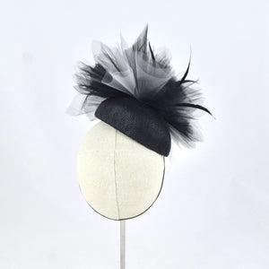 Black sinamay tear drop percher with black and grey tulle, black sculpted feathers, and vintage leather buckle. Back view.
